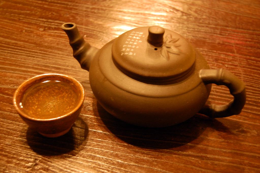 A cup of tea and a teapot on a table